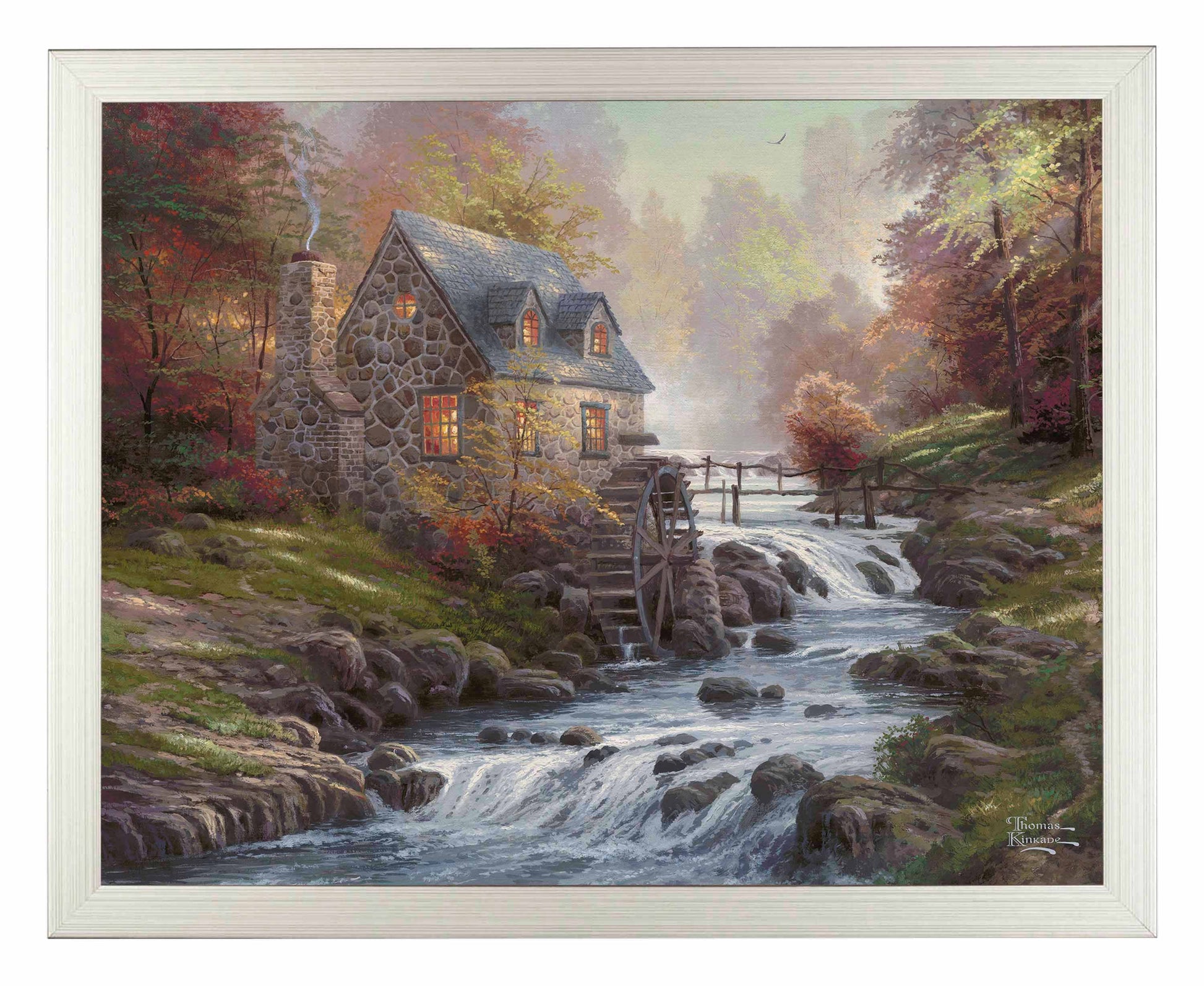 Framed painting of cobblestone house and trees by the river