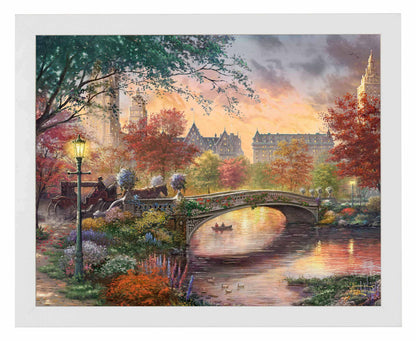 Framed painting of autumn in New York showing a bridge and trees by the river