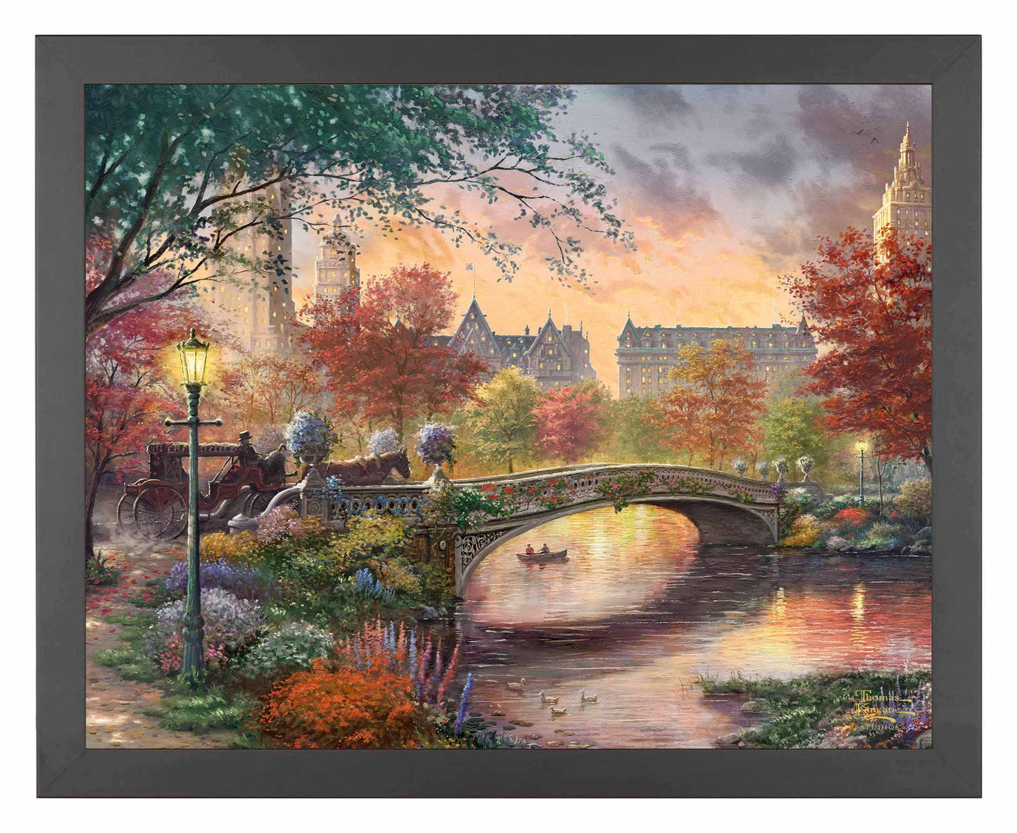 Framed painting of autumn in New York showing a bridge and trees by the river