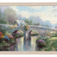 Framed painting of a bridge and trees by the lake