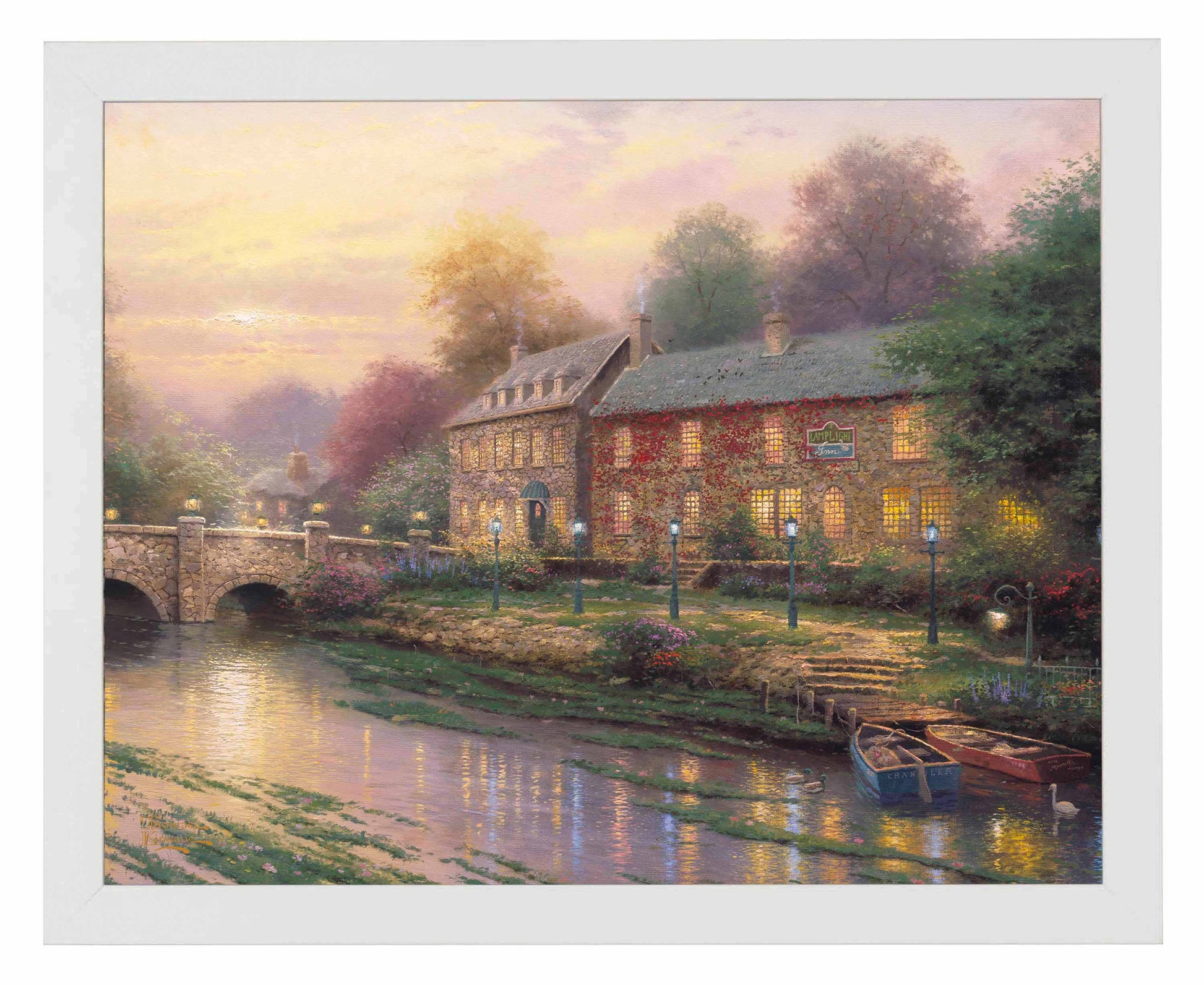 Framed painting of an inn with lamplights and a bridge by the river