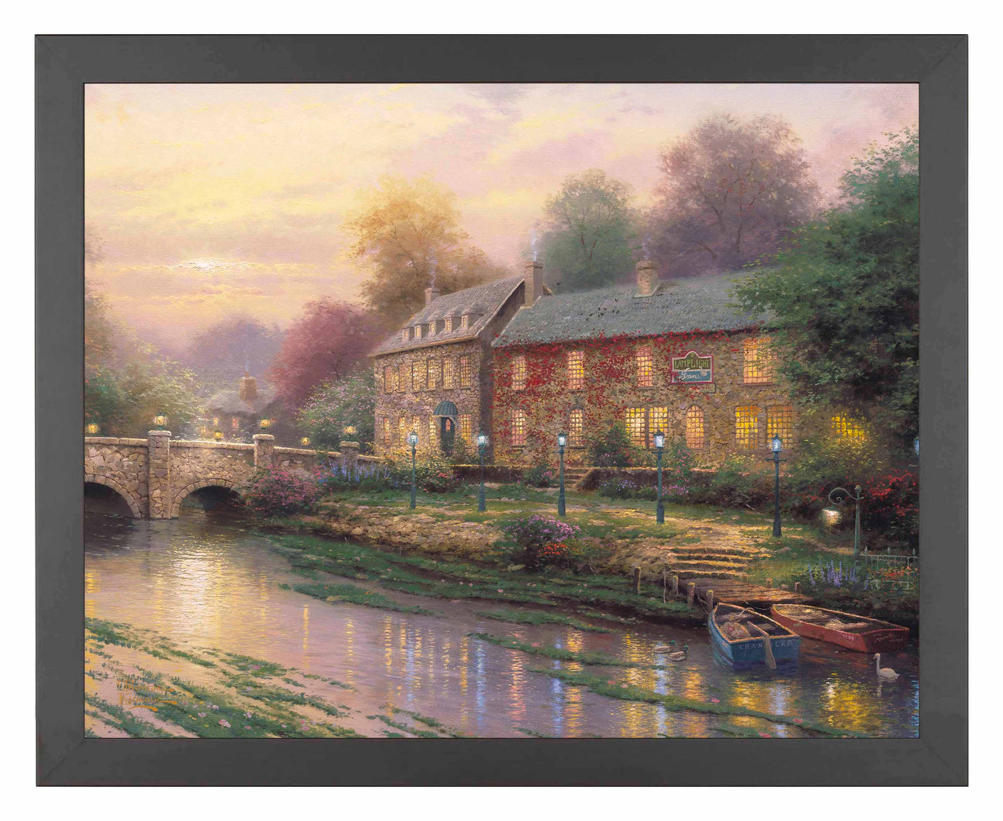 Framed painting of an inn with lamplights and a bridge by the river