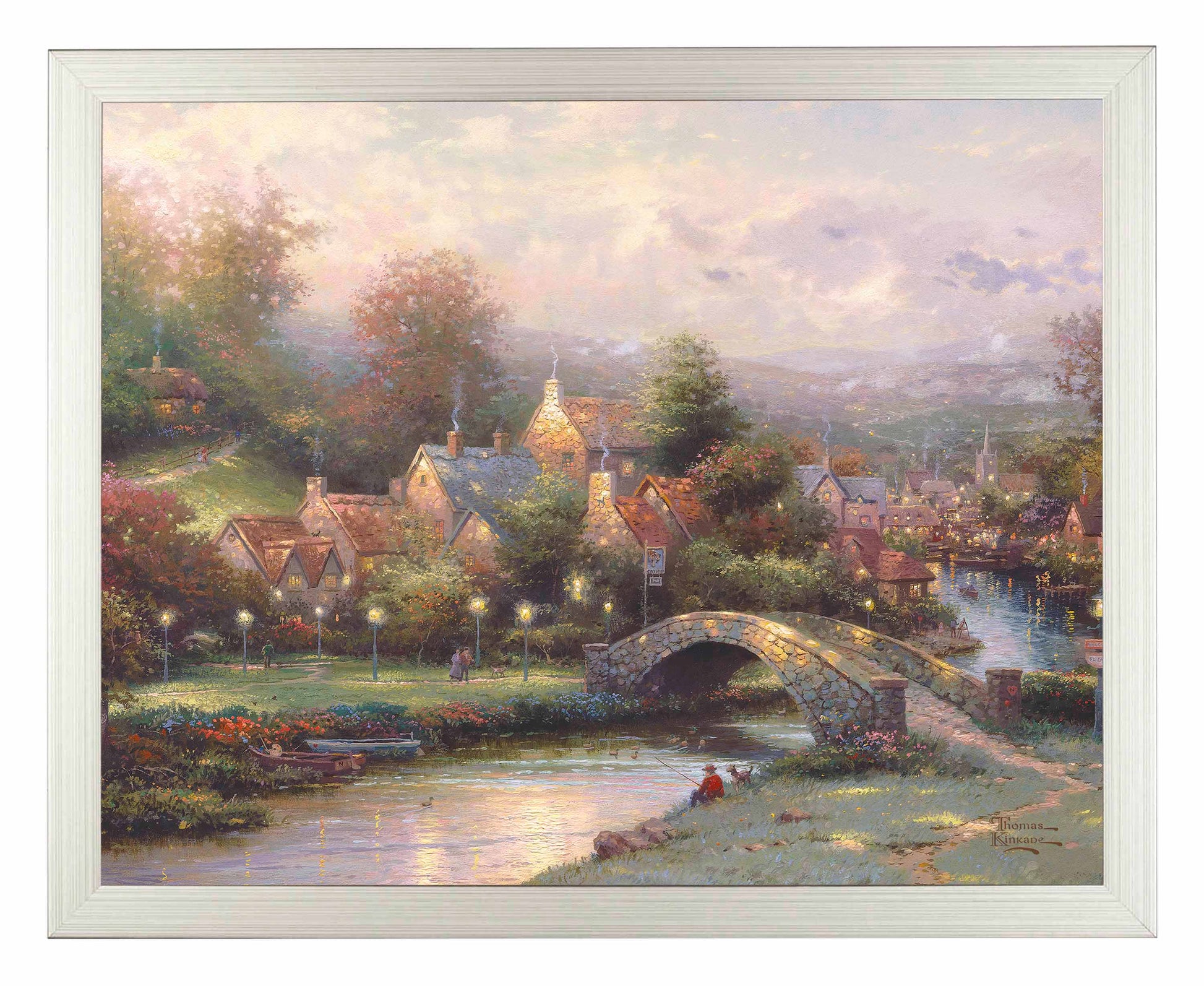 Framed painting of a village with houses, trees and a bridge by the river