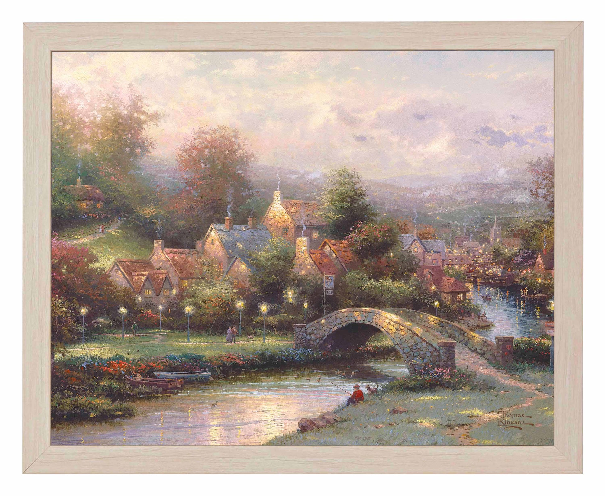 Framed painting of a village with houses, trees and a bridge by the river