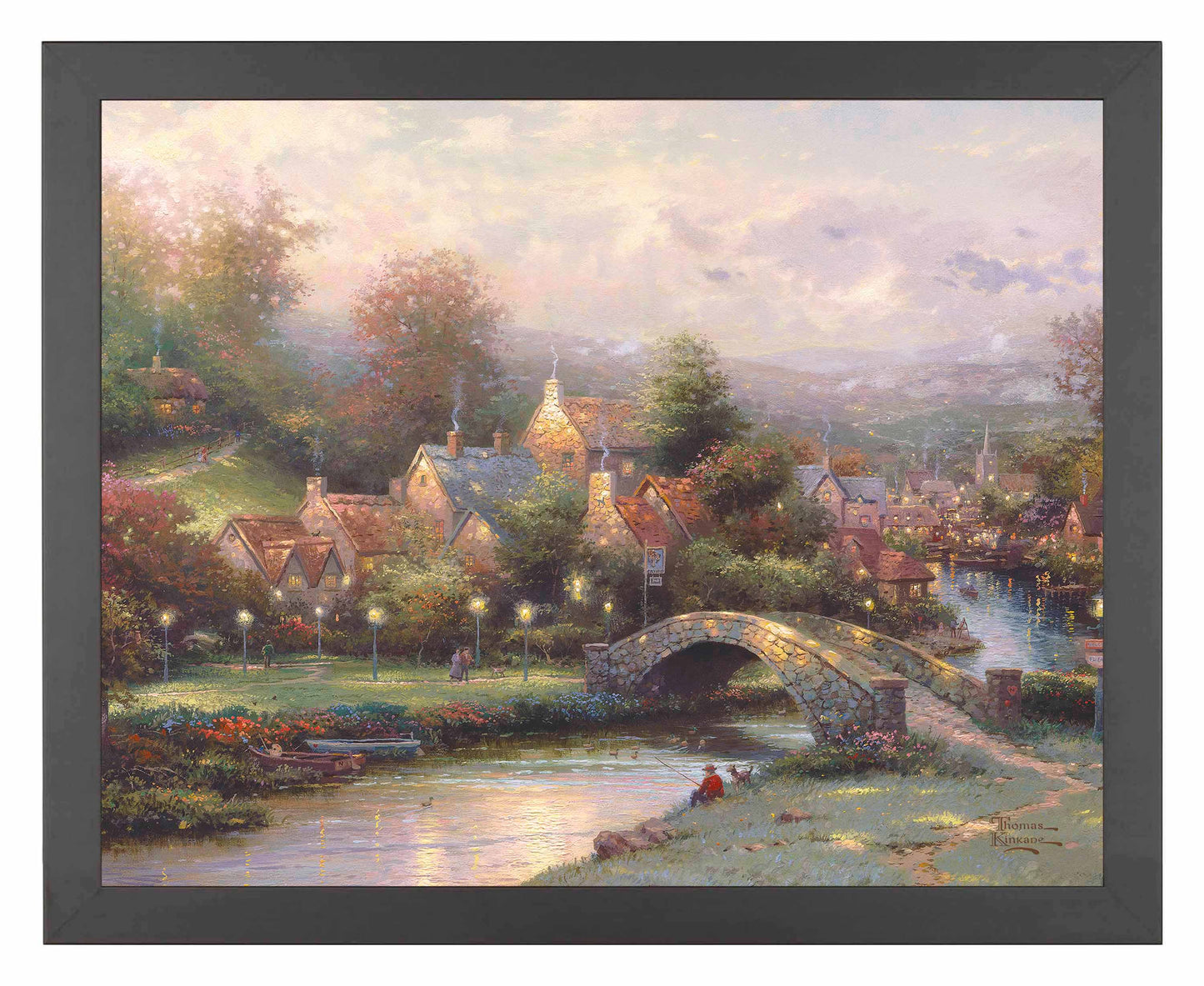 Framed painting of a village with houses, trees and a bridge by the river