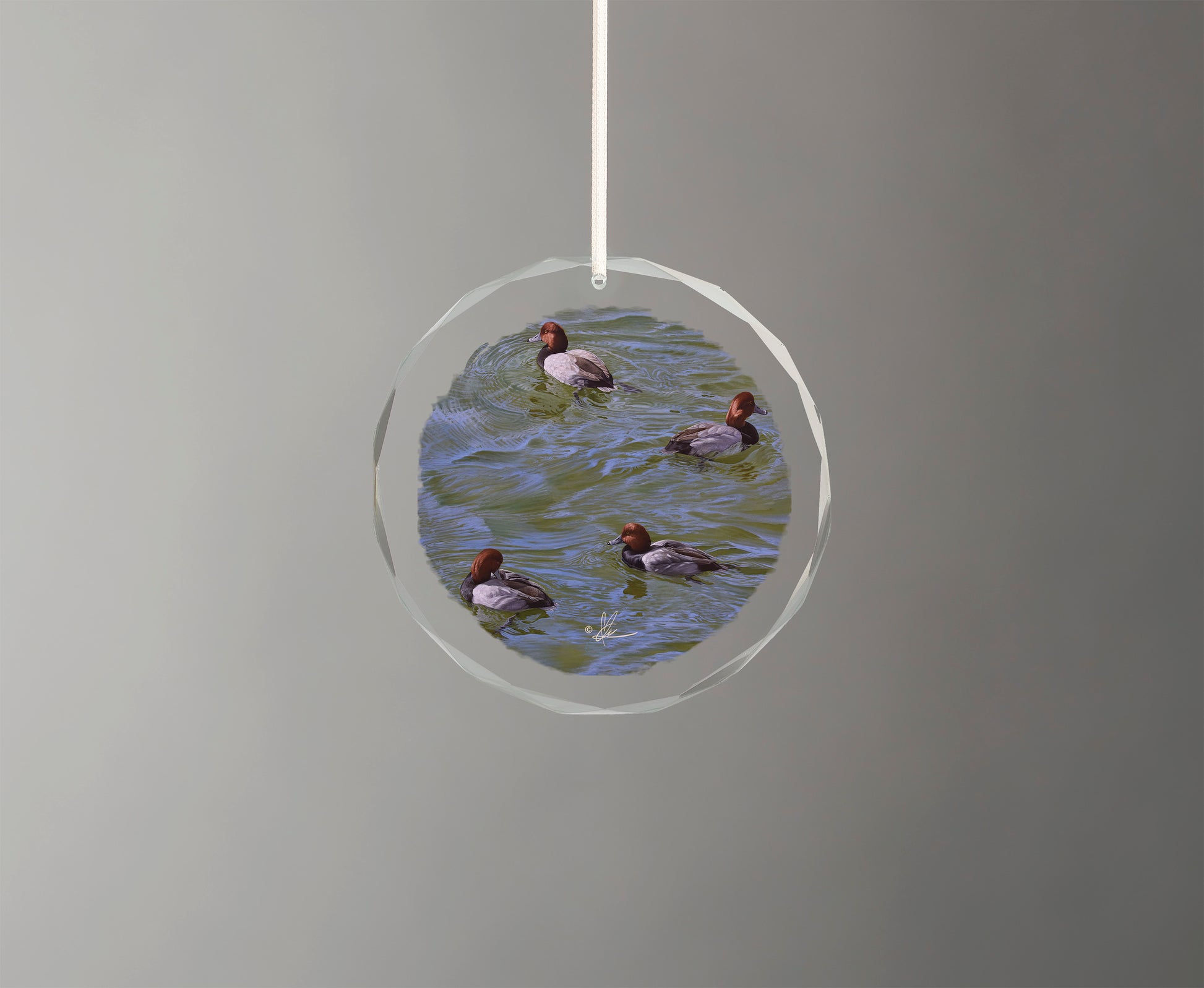 Glass ornament with little swimming ducks