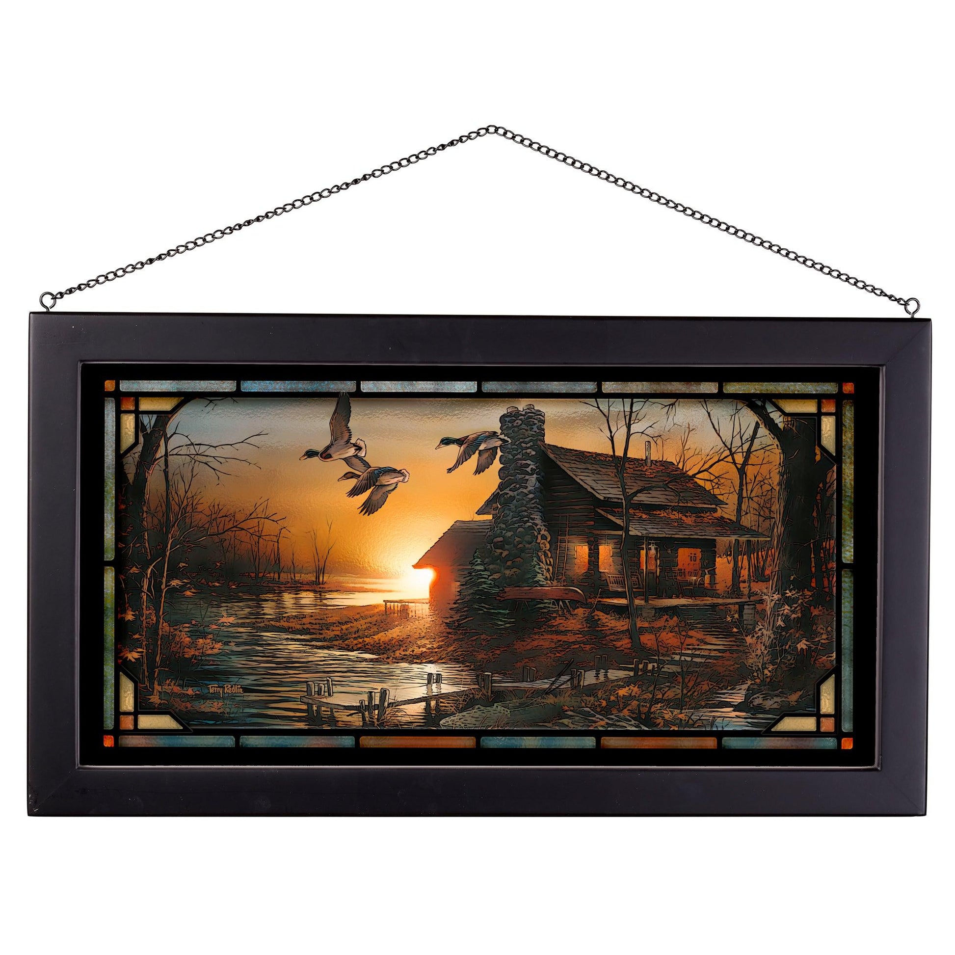 Framed painting of sunset with a house by the river